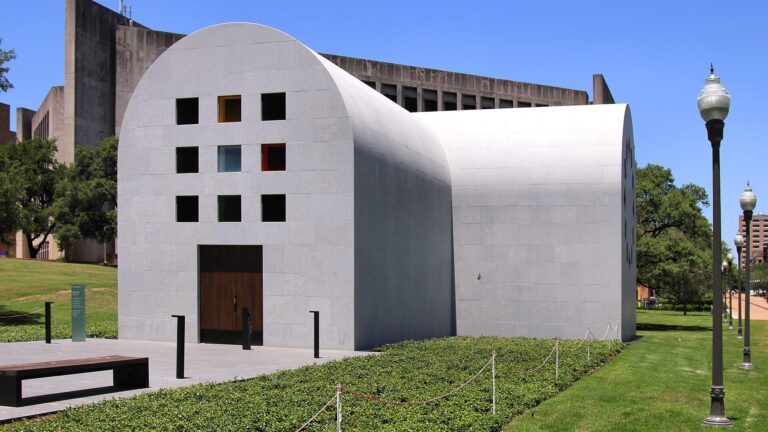 Ellsworth Kelly's pale stone chapel "Austin" with its coloured glass windows on the lawn outside the Blanton Museum of Art