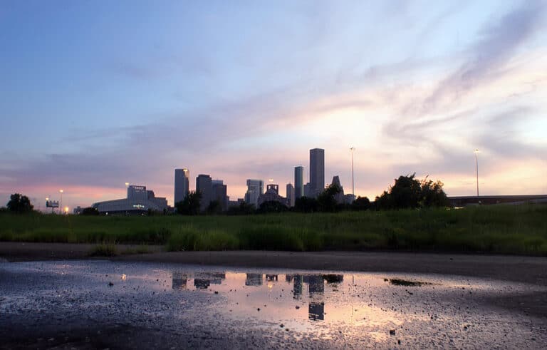 Downtown Houston skyline at sunset, seen across a park near the Texas Medical Center
