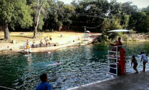 Swimmers enjoying Barton Springs Pool in Austin, Texas on a summer day