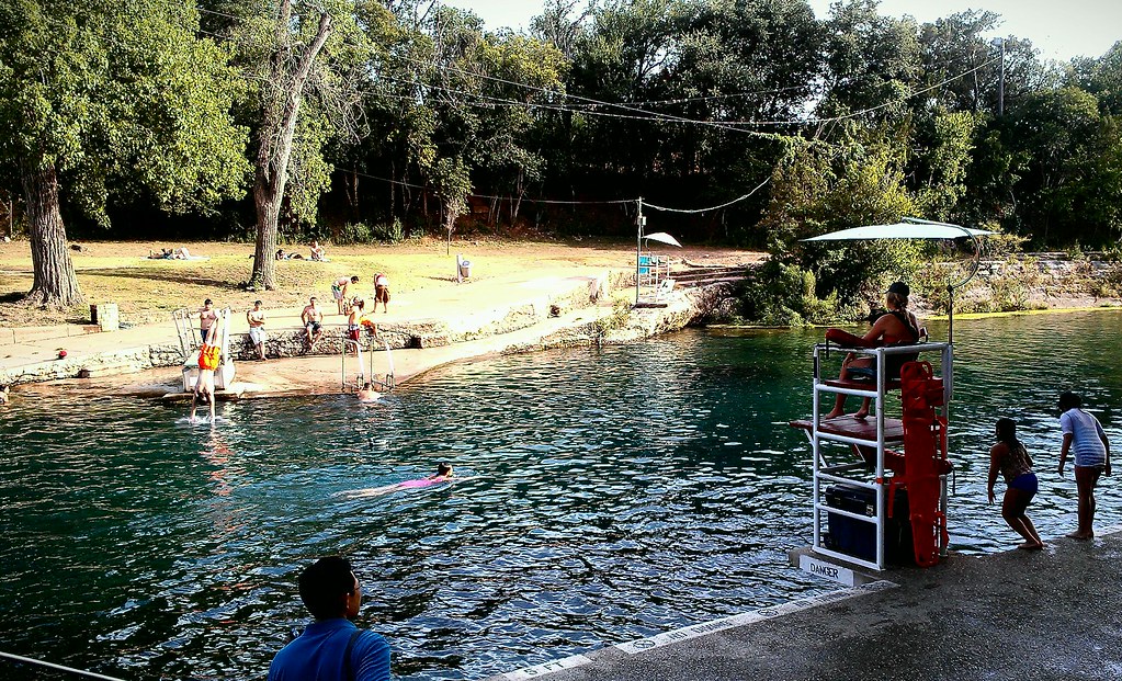 Swimmers enjoying Barton Springs Pool in Austin, Texas on a summer day